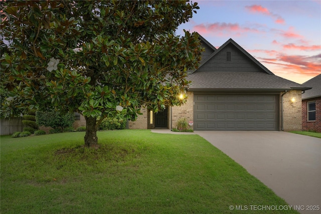 4675 E 144th Pl S, Bixby, OK 74008 - view of front of home with a garage, driveway, a lawn, and brick siding