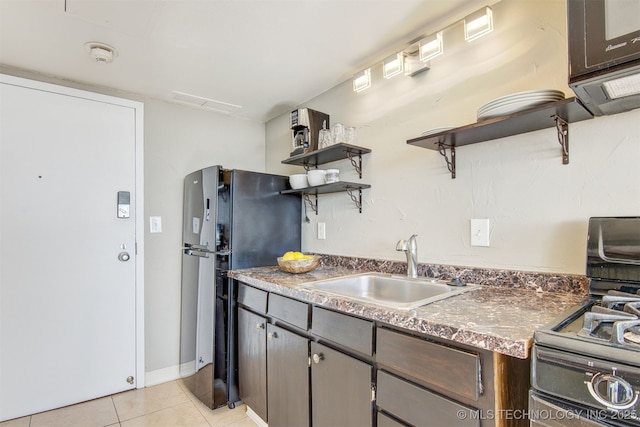 410 W 7th St Unit 1230, Tulsa, OK 74119 - kitchen with open shelves, stainless steel range with gas stovetop, a sink, freestanding refrigerator, and light tile patterned flooring