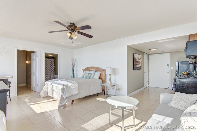 410 W 7th St Unit 1230, Tulsa, OK 74119 - bedroom featuring freestanding refrigerator, light tile patterned floors, ceiling fan, and baseboards