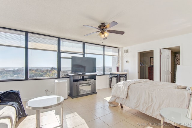 410 W 7th St Unit 1230, Tulsa, OK 74119 - bedroom featuring multiple windows and light tile patterned flooring