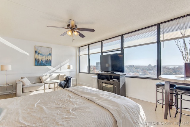 410 W 7th St Unit 1230, Tulsa, OK 74119 - bedroom with baseboards and light tile patterned flooring