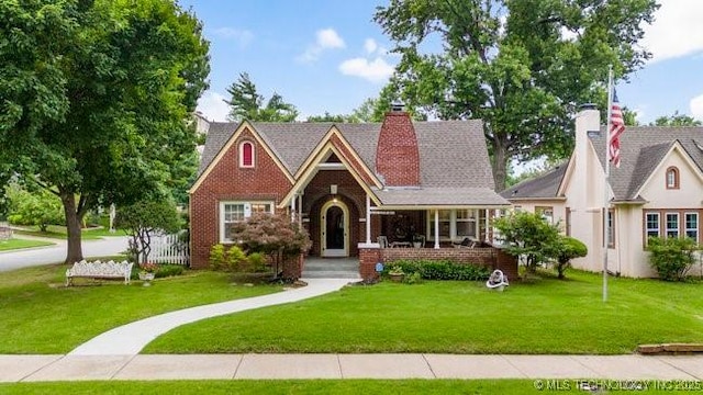 2403 S Troost Ave, Tulsa, OK 74114 - view of front facade featuring a front lawn, brick siding, and a porch
