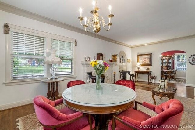 2403 S Troost Ave, Tulsa, OK 74114 - dining area with a chandelier, crown molding, plenty of natural light, wood finished floors, and baseboards