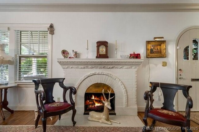 2403 S Troost Ave, Tulsa, OK 74114 - living area featuring wood finished floors, baseboards, and a brick fireplace