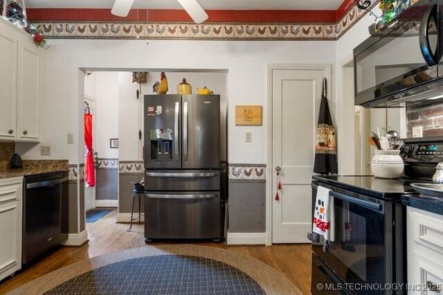 2403 S Troost Ave, Tulsa, OK 74114 - kitchen with black appliances, wood finished floors, a ceiling fan, white cabinetry, and baseboards