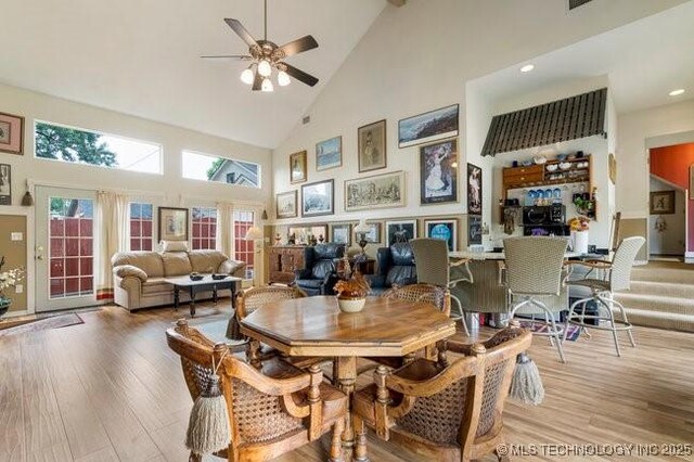 2403 S Troost Ave, Tulsa, OK 74114 - dining room featuring high vaulted ceiling, a ceiling fan, wood finished floors, and recessed lighting