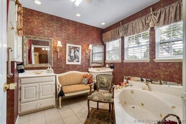 2403 S Troost Ave, Tulsa, OK 74114 - bathroom featuring wallpapered walls, a tub with jets, tile patterned floors, and vanity
