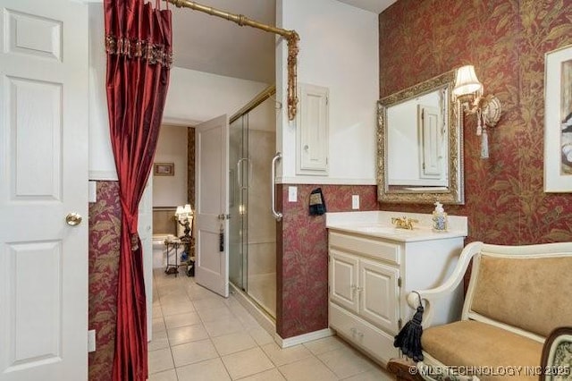 2403 S Troost Ave, Tulsa, OK 74114 - bathroom featuring wallpapered walls, a shower stall, tile patterned flooring, wainscoting, and vanity