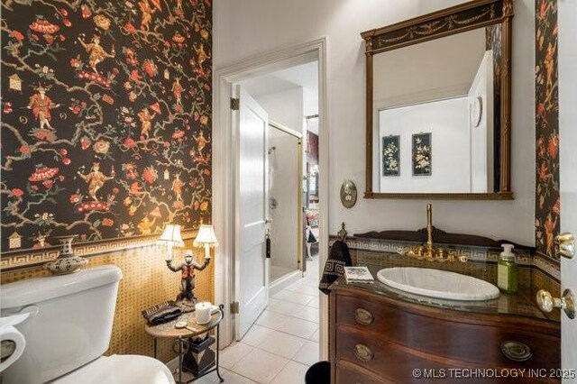 2403 S Troost Ave, Tulsa, OK 74114 - bathroom with wallpapered walls, vanity, toilet, and tile patterned floors