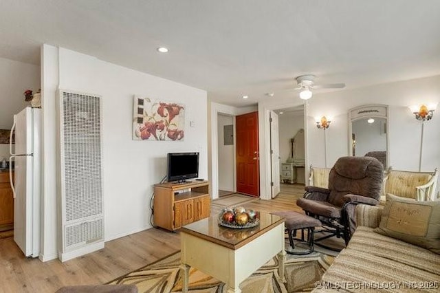 2403 S Troost Ave, Tulsa, OK 74114 - living area featuring a heating unit, light wood-type flooring, ceiling fan, and recessed lighting