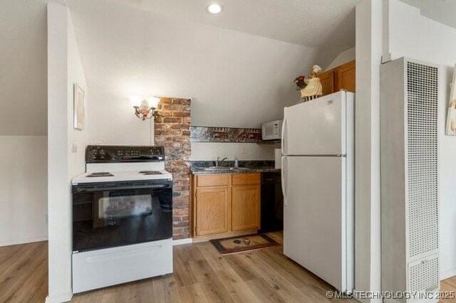 2403 S Troost Ave, Tulsa, OK 74114 - kitchen featuring white appliances, a heating unit, lofted ceiling, light wood-type flooring, and a sink