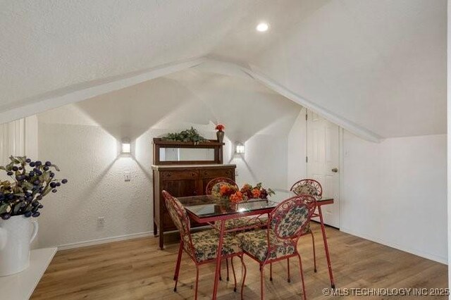 2403 S Troost Ave, Tulsa, OK 74114 - dining area featuring lofted ceiling, wood finished floors, and baseboards