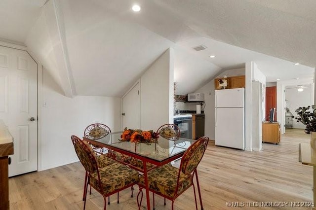 2403 S Troost Ave, Tulsa, OK 74114 - dining room with vaulted ceiling, light wood-type flooring, and recessed lighting