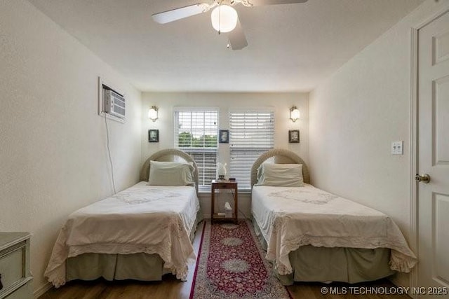 2403 S Troost Ave, Tulsa, OK 74114 - bedroom with a wall mounted air conditioner, wood finished floors, and ceiling fan
