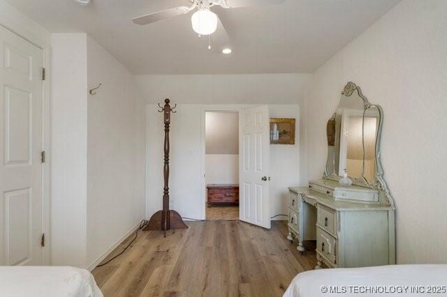 2403 S Troost Ave, Tulsa, OK 74114 - bedroom with light wood-style floors and a ceiling fan