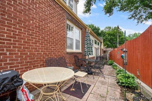2403 S Troost Ave, Tulsa, OK 74114 - fenced backyard with outdoor dining area and a patio area