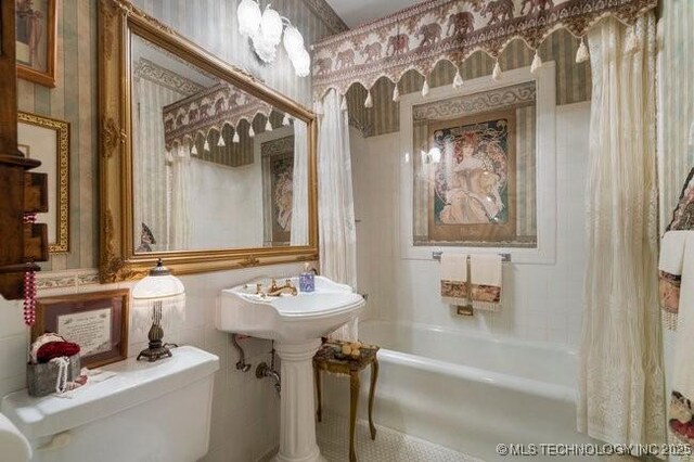 2403 S Troost Ave, Tulsa, OK 74114 - bathroom featuring toilet, shower / bath combo, and wallpapered walls