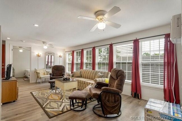 2403 S Troost Ave, Tulsa, OK 74114 - living area featuring a ceiling fan, plenty of natural light, light wood-style flooring, a wall mounted air conditioner, and recessed lighting