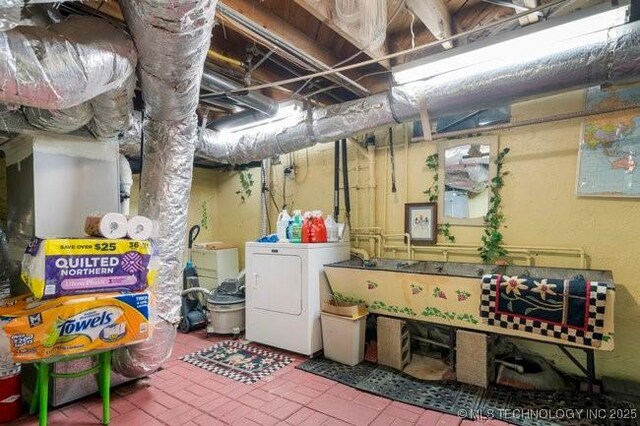 2403 S Troost Ave, Tulsa, OK 74114 - unfinished basement with independent washer and dryer and brick patterned flooring