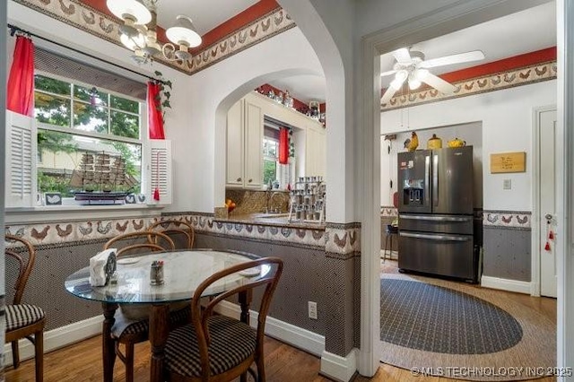 2403 S Troost Ave, Tulsa, OK 74114 - dining room featuring arched walkways, plenty of natural light, ceiling fan, and a chandelier