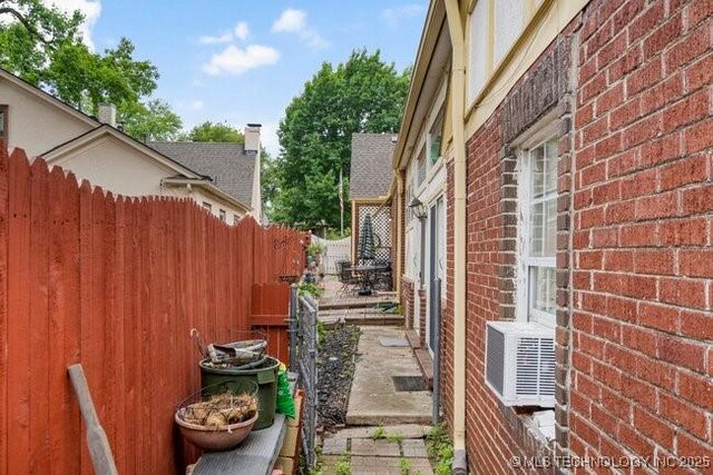 2403 S Troost Ave, Tulsa, OK 74114 - view of side of home featuring brick siding