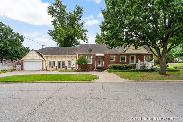 2403 S Troost Ave, Tulsa, OK 74114 - view of front facade with concrete driveway and an attached garage