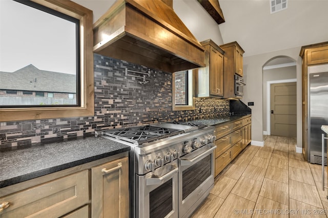 3805 S Tamarack Ave, Broken Arrow, OK 74011 - kitchen featuring high quality appliances, custom range hood, dark countertops, and tasteful backsplash