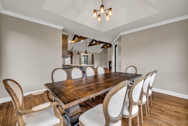 3805 S Tamarack Ave, Broken Arrow, OK 74011 - dining room featuring a chandelier, baseboards, and wood finished floors