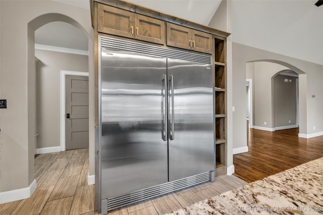 3805 S Tamarack Ave, Broken Arrow, OK 74011 - kitchen with stainless steel built in fridge, arched walkways, light wood-type flooring, baseboards, and ornamental molding