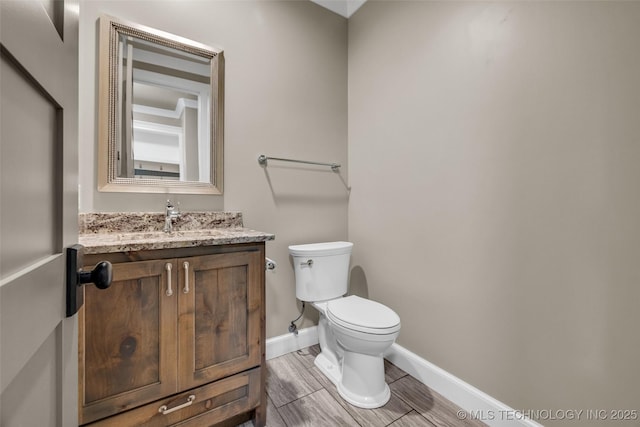3805 S Tamarack Ave, Broken Arrow, OK 74011 - bathroom with toilet, vanity, baseboards, and wood finish floors