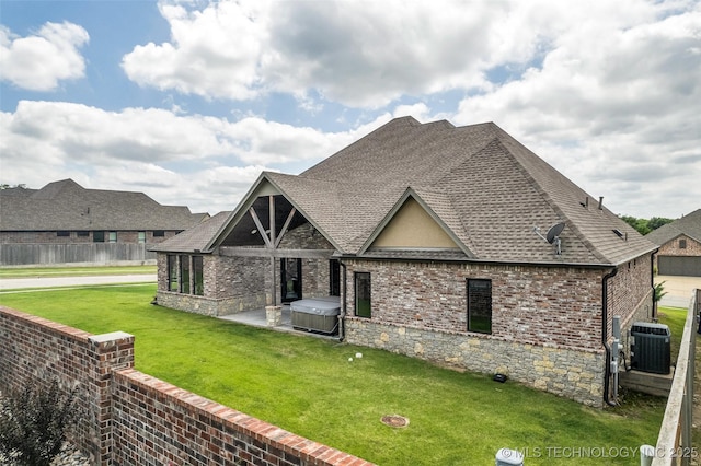 3805 S Tamarack Ave, Broken Arrow, OK 74011 - back of property with a hot tub, a shingled roof, cooling unit, a patio area, and brick siding