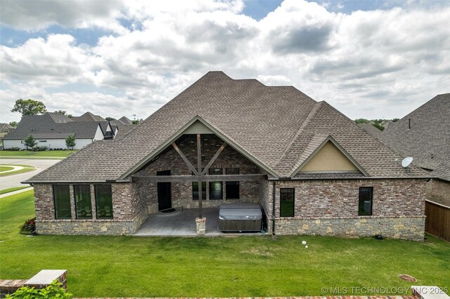 3805 S Tamarack Ave, Broken Arrow, OK 74011 - rear view of house with a hot tub, a patio, a shingled roof, a yard, and brick siding