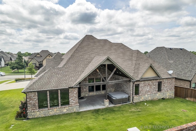 3805 S Tamarack Ave, Broken Arrow, OK 74011 - rear view of house featuring a hot tub, a patio, stone siding, and a shingled roof