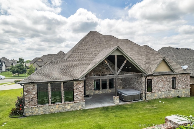 3805 S Tamarack Ave, Broken Arrow, OK 74011 - rear view of property featuring a hot tub, a patio area, a shingled roof, a yard, and stone siding