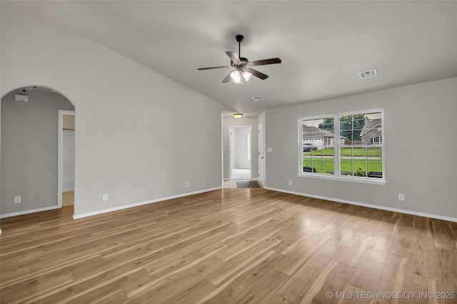 9220 S 256th E Ave, Broken Arrow, OK 74014 - spare room featuring arched walkways, a ceiling fan, lofted ceiling, light wood-type flooring, and baseboards