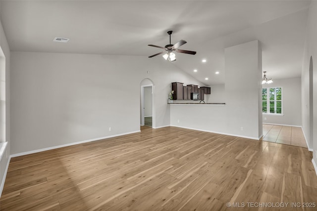 9220 S 256th E Ave, Broken Arrow, OK 74014 - unfurnished living room featuring ceiling fan, light wood-style flooring, arched walkways, a chandelier, and lofted ceiling