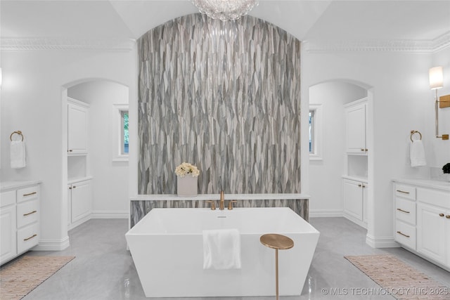 3121 S Rockford Dr, Tulsa, OK 74105 - full bath with vanity, a freestanding bath, lofted ceiling, and baseboards