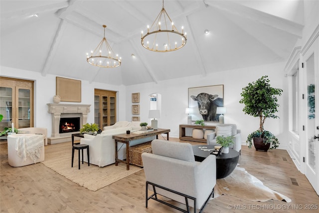 3121 S Rockford Dr, Tulsa, OK 74105 - living area with high vaulted ceiling, a chandelier, beam ceiling, a lit fireplace, and light wood-type flooring