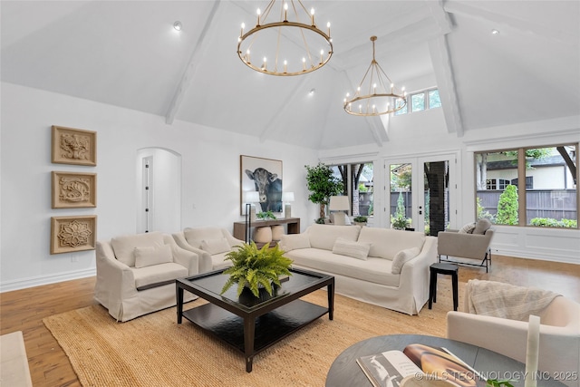 3121 S Rockford Dr, Tulsa, OK 74105 - living room featuring a chandelier, high vaulted ceiling, beam ceiling, light wood-style flooring, and arched walkways