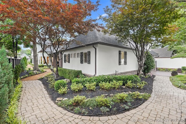 3121 S Rockford Dr, Tulsa, OK 74105 - view of property exterior featuring stucco siding and a shingled roof