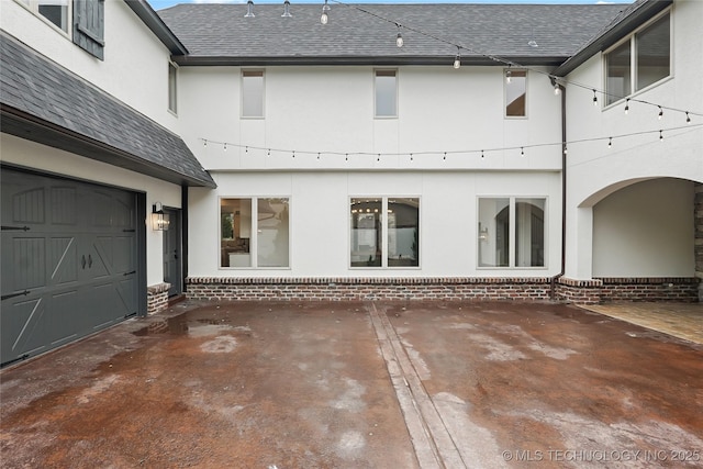 3121 S Rockford Dr, Tulsa, OK 74105 - rear view of house featuring stucco siding, a garage, and a shingled roof