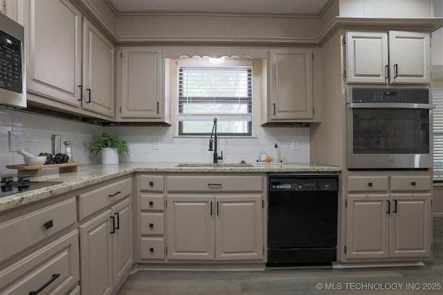 2604 W Broadway St, Broken Arrow, OK 74012 - kitchen with black appliances, a sink, light stone countertops, and wood finished floors