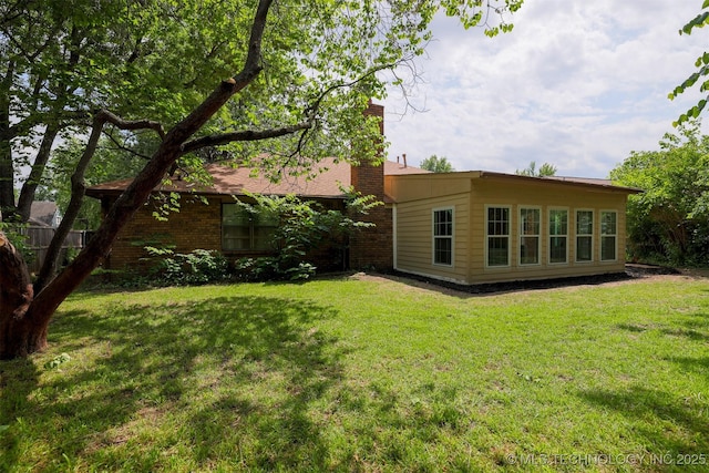 2604 W Broadway St, Broken Arrow, OK 74012 - rear view of property featuring a chimney and a yard