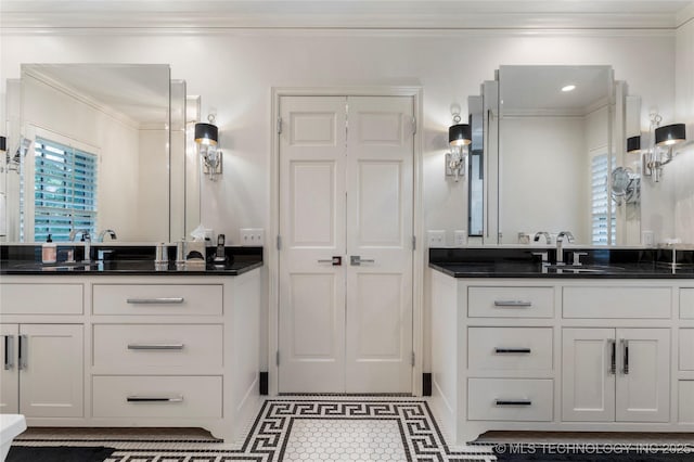 1764 E 30th St, Tulsa, OK 74114 - bathroom featuring crown molding, two vanities, and baseboards