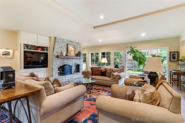 1764 E 30th St, Tulsa, OK 74114 - living room featuring wood finished floors, recessed lighting, a stone fireplace, and a wood stove