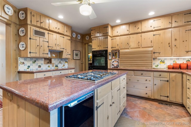 1764 E 30th St, Tulsa, OK 74114 - kitchen with black oven, stainless steel gas cooktop, tasteful backsplash, ceiling fan, and a kitchen island