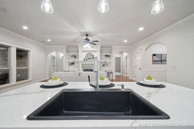 16121 E 78th St, Owasso, OK 74055 - kitchen featuring arched walkways, ornamental molding, recessed lighting, a ceiling fan, and a sink
