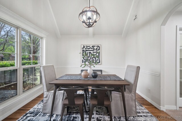 16121 E 78th St, Owasso, OK 74055 - dining area with arched walkways, a chandelier, wood finished floors, and baseboards
