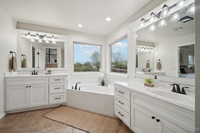 16121 E 78th St, Owasso, OK 74055 - ensuite bathroom featuring two vanities, a garden tub, tile patterned floors, and recessed lighting