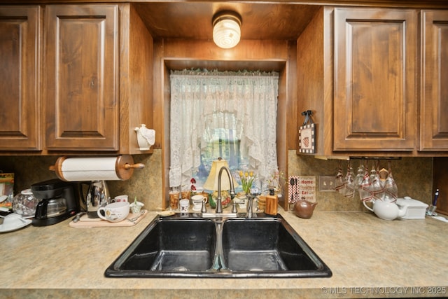 3504 S Rolling Oaks Dr, Tulsa, OK 74107 - kitchen featuring light countertops, tasteful backsplash, and brown cabinets
